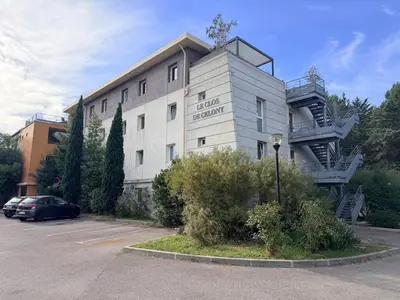 a building with a spiral staircase on the side of it at Le Clos d'AIX studio 211 in Aix-en-Provence