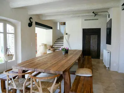 a dining room with a wooden table and chairs at Stunning Stone House With Pool Near Gordes in Gordes