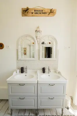 a bathroom with two sinks and two mirrors at La Maison de Claire à Plan d'Orgon in Plan-dʼOrgon