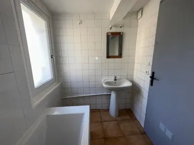 a white bathroom with a sink and a mirror at Maison lumineuse proche du centre in Carpentras