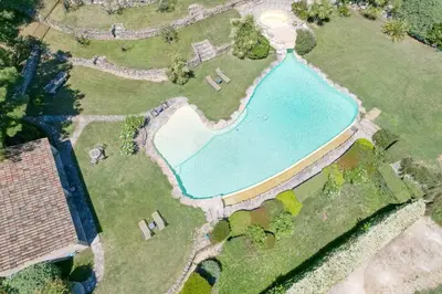 an overhead view of a swimming pool in a yard at Mas, Padel privé, tennis privé, piscine 22m , Alpilles Provence in Orgon