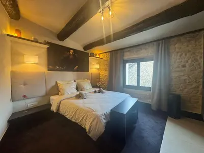 a bedroom with a bed and a window at Auberge Nostradamus, Appartement 4 in Salon-de-Provence