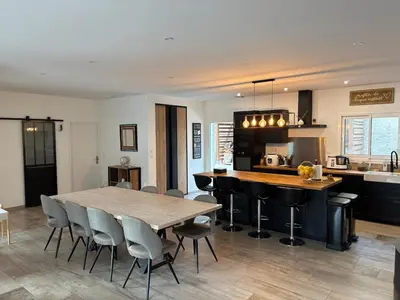 a kitchen and dining room with a table and chairs at Grande maison familiale tout confort in Éguilles