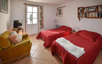 a bedroom with two beds and a couch and a tv at Pet Friendly Home In Gargas With Wifi in Gargas