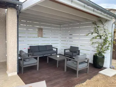 a patio with two couches and a table and chairs at La Maison De Paulette in Joucas
