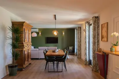 a living room with a table and a couch at La Maison De Paulette in Joucas