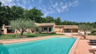 a swimming pool in front of a house at La Bergerie de Saignon in Saignon