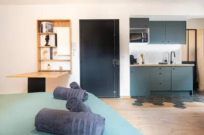 a kitchen with two teddy bears sitting on a bed at Studio Cosy au Cœur de la Ville in Salon-de-Provence