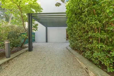 an open garage door with a green hedge at Le Casanelle in Aix-en-Provence