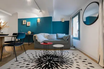 a living room with a couch and a table at 2 rooms apartment in the city center in Aix-en-Provence