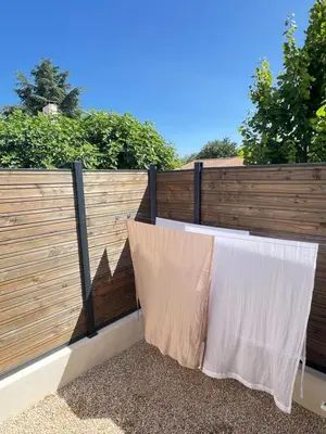 a fence with two white pillows on it at Terres de Durance in Charleval