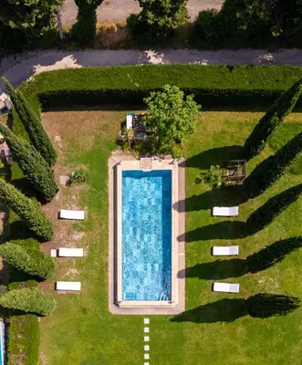 an overhead view of a swimming pool in a garden at CHATEAU 18e AVEC PISCINE in La Celle-sous-Gouzon