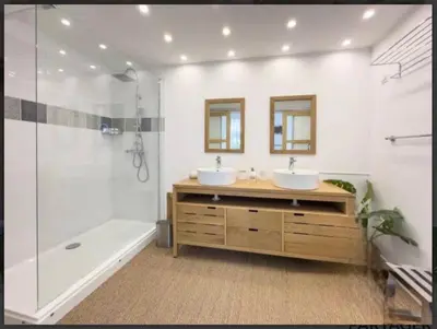 a bathroom with two sinks and a shower and a tub at CHATEAU 18e AVEC PISCINE in La Celle-sous-Gouzon
