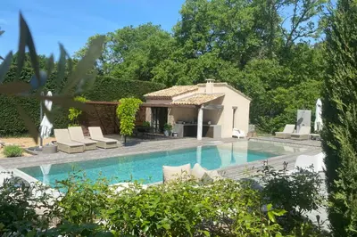 a swimming pool with chairs and a house at House for rent in Ménerbes Villa Carpe Diem in Ménerbes
