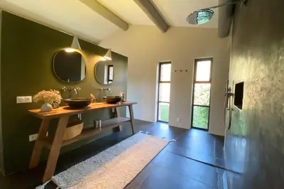 a bathroom with two sinks and two mirrors at House for rent in Ménerbes Villa Carpe Diem in Ménerbes