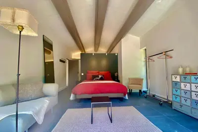 a bedroom with a large bed and a couch at House for rent in Ménerbes Villa Carpe Diem in Ménerbes