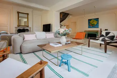 a living room with a couch and a table at Mas de La Lombarde Saint Rémy de Provence in Saint-Rémy-de-Provence