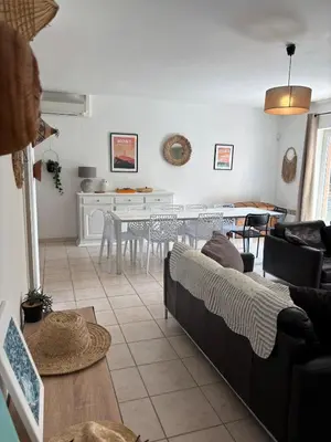 a living room with a couch and a table at Jolie maison avec piscine , proche du centre de Bédoin in Bédoin