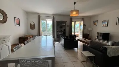 a living room with a large table and a couch at Jolie maison avec piscine , proche du centre de Bédoin in Bédoin