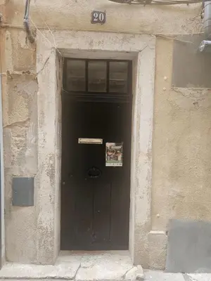 a black door in a building with a sign on it at Charmant Appartement Aixois in Aix-en-Provence