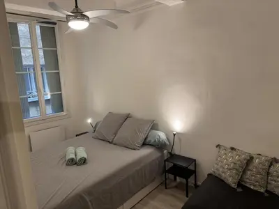 a bedroom with a bed with two shoes on it at Charmant Appartement Aixois in Aix-en-Provence