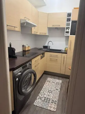 a kitchen with a washing machine on the floor at Charmant Appartement Aixois in Aix-en-Provence