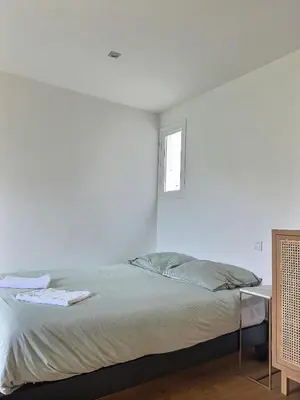 a white bedroom with a bed and a window at Studio centre Aix - Climatisé avec terrasse in Aix-en-Provence