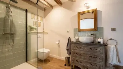a bathroom with a sink and a glass shower at A typical provençal house in Mollégès