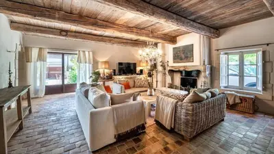 a living room with couches and a fireplace at A typical provençal house in Mollégès