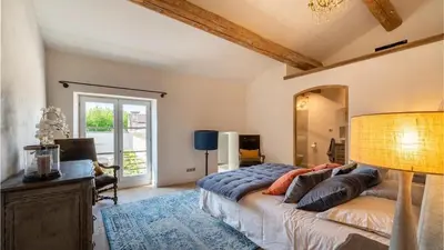 a bedroom with a bed and a large mirror at A typical provençal house in Mollégès