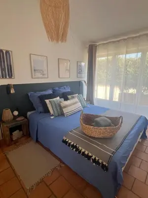 a bedroom with a blue bed with a basket on it at Suite privée tout confort in Gargas