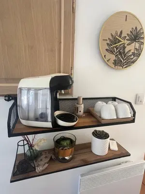 a kitchen shelf with a toaster and other kitchen items at Suite privée tout confort in Gargas