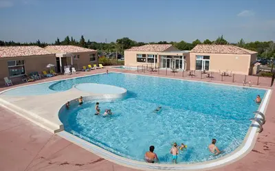 a group of people in a large swimming pool at Maison Les Demeures du Ventoux in Aubignan