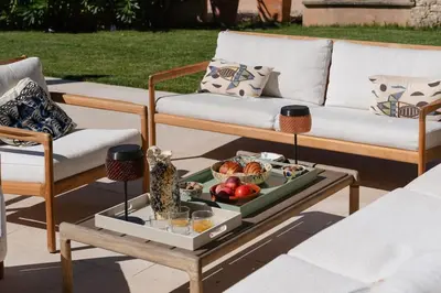a coffee table with a tray of food on a patio at Spacious villa in Provence in Le Puy-Sainte-Réparade