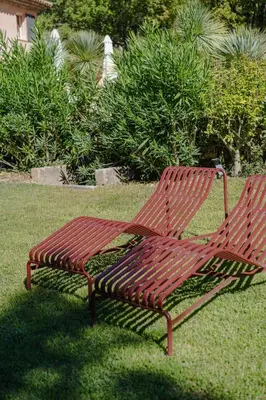 two benches sitting on the grass in a park at Spacious villa in Provence in Le Puy-Sainte-Réparade