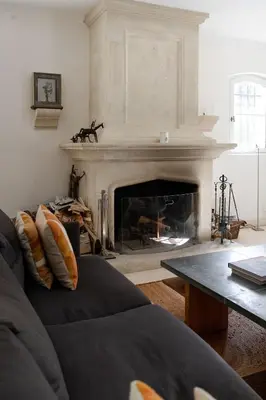 a living room with a fireplace and a couch at Spacious villa in Provence in Le Puy-Sainte-Réparade