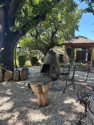 a park with a tree and a stone oven at Estate in Provence in Aix-en-Provence