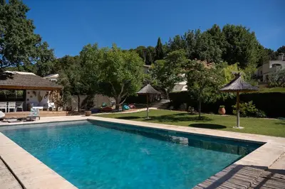 a swimming pool with blue water in a yard at Estate in Provence in Aix-en-Provence