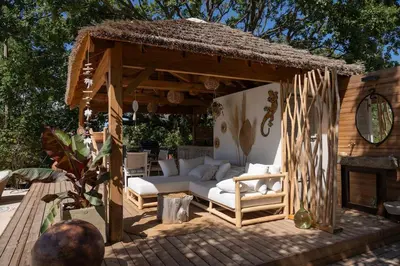 a wooden gazebo with a couch and a fireplace at Estate in Provence in Aix-en-Provence