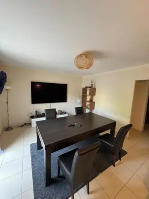 a dining room with a table and chairs and a television at Appartement dans Aix-en-Provence - Sainte Victoire in Saint-Marc-Jaumegarde