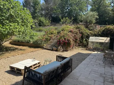 a patio with two benches and a table and stairs at Appartement dans Aix-en-Provence - Sainte Victoire in Saint-Marc-Jaumegarde