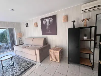 a living room with a couch and an elephant picture on the wall at Studio Velaux in Velaux