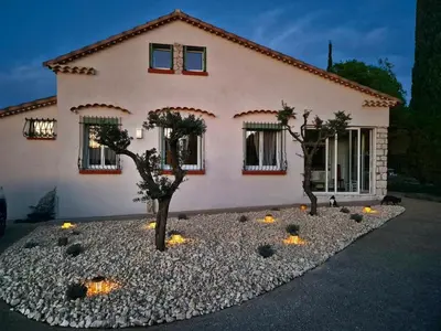 a house with a tree in front of it at Villa grand confort, piscine privée, petanque, pool house in Alleins