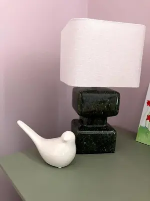 a black and white lamp sitting on a table next to a white object at Une Parenthèse Aixoise in Aix-en-Provence