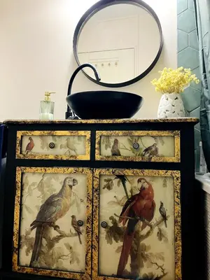 a dresser with pictures of birds on it with a mirror at Une Parenthèse Aixoise in Aix-en-Provence