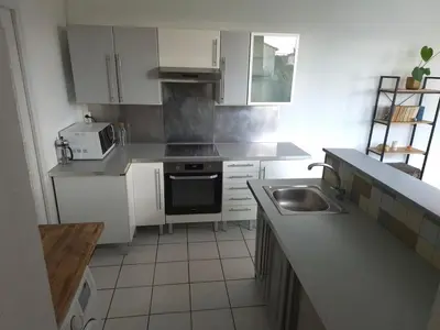 a small kitchen with white cabinets and a sink at Provence Studio 33 m2 in Cavaillon