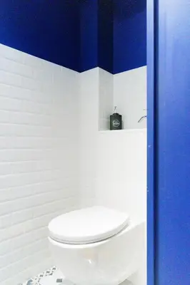 a bathroom with a white toilet and blue walls at T4 Aix PARKING CLIM refait a neuf in Aix-en-Provence
