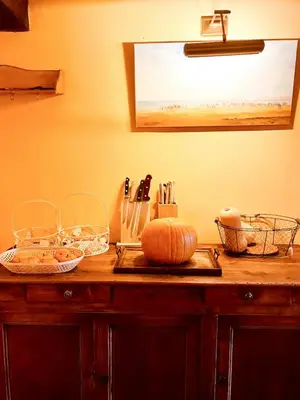 a kitchen counter with a table with a pumpkin on it at Stone House Within Castle Ramparts In Goult in Goult