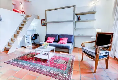 a living room with a couch and a table at Aude Loft in Aix-en-Provence
