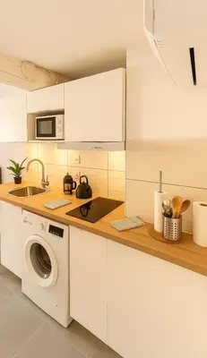 a kitchen with a washing machine and a sink at T2 Duplex climatisé Suite et canapé-lit Aix centre in Aix-en-Provence
